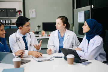 Medical, meeting and laptop for team in discussion, brainstorming and planning. Doctor, nurse on desk show diversity in collaboration, teamwork or workshop in hospital .