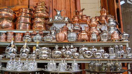 Ornate Copper and Silver Metal Tableware in Market Display