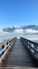 Obraz premium Wooden pier leading to misty mountain lake