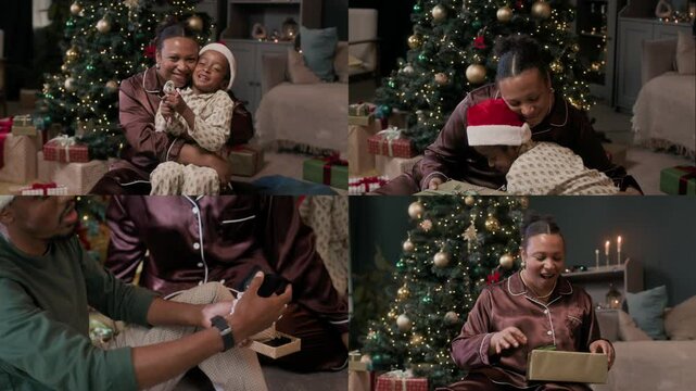 Modern African American family with kid wearing pyjamas exchanging and opening Christmas gifts while sitting on floor in cozy living room