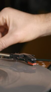 Vintage turntable close-up. Needle glides across the spinning silver record. 4k vertical video.