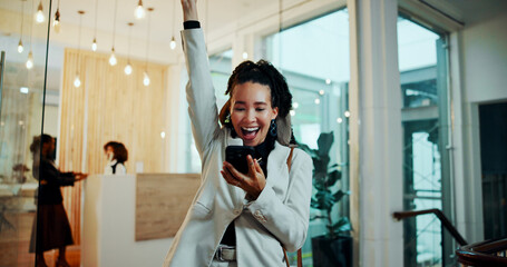 Business woman, phone and celebration at hotel, lobby and excited with good news, deal or...