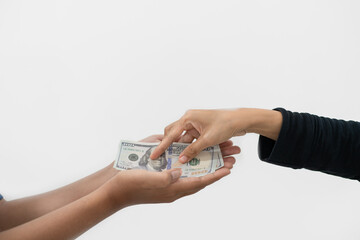 woman's hand giving dollar bill to man's hand, isolated on white background.