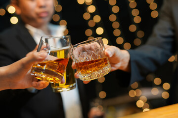 food and drink male friends are happy drinking beer and clinking glasses at a bar or pub.