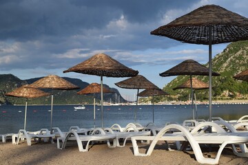 Sunbeds and umbrellas on the beach of Icmeler. Marmaris