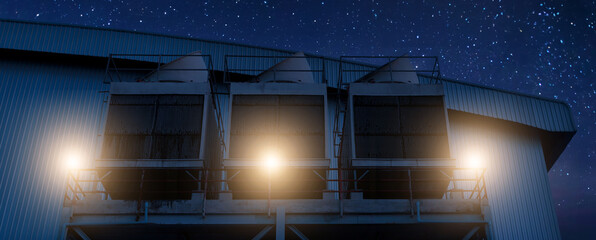 Cooling towers in data center building. Air conditioning cooling towers in front of building with...