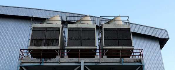 Cooling towers in data center building. Air conditioning cooling towers in front of building with...