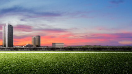 Empty football field with pitch line on green grass with cityscapes. The field is ready for a game