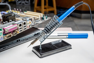 Electric solder with lead solder and motherboard circuit board on the table