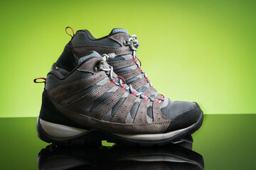 studio shoot a pair of black gray hiking boots, shoes isolated on natural green background