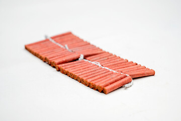 Red fire crackers string isolated over white background