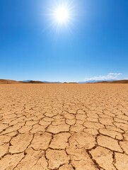Explore the breathtaking beauty of a vast sunlit desert landscape with cracked earth and clear blue skies