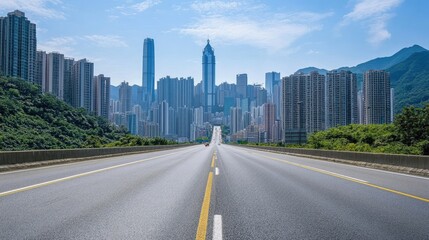 Fototapeta premium A long, empty road stretches towards a towering city skyline.