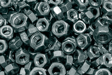Steel hexagonal hex metric nuts background backdrop in a various assortment of sizes.