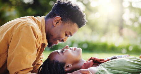 Love, relax and black couple in park for bonding, connection and happy outdoor adventure on weekend. Smile, man and woman on picnic for romantic date, morning fun and embrace together in green garden
