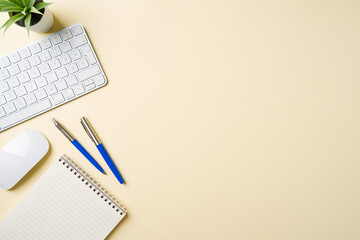 Office desk with computer keyboard, mouse, notebook and pen. Top view with copy space. Flat lay
