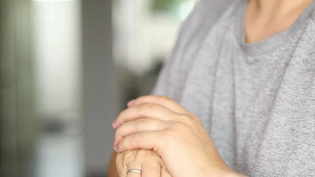 Close up of female hands appalling creme moisturizer on her hands. Blurry background 