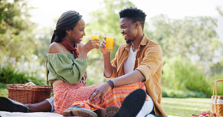 Nature, picnic and black couple toast with juice on blanket for bonding, relationship and trust...