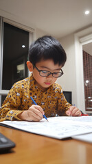 Responsible 9-year-old boy doing his schoolwork in his room. Concept: study
