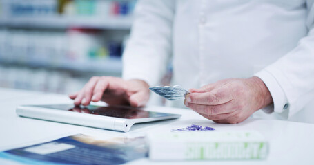 Pharmacist, hands or typing on tablet with pills for online order, prescription medication or...