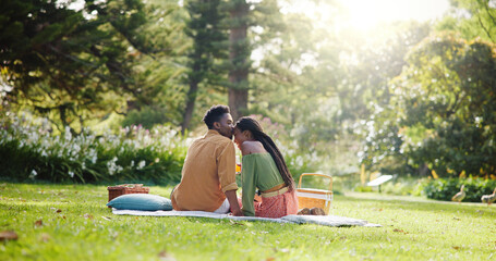 Back, kiss and love with black couple and picnic for bonding, happiness and romantic date. Calm,...
