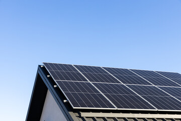 Modern house with solar panels stand-alone photovoltaic plant system on household metal sheet...