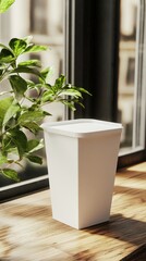 A clean and simple food box mockup stands upright on a wooden surface in bright daylight