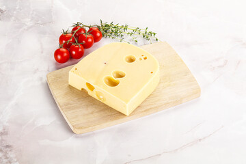 Maasdam cheese brick over board
