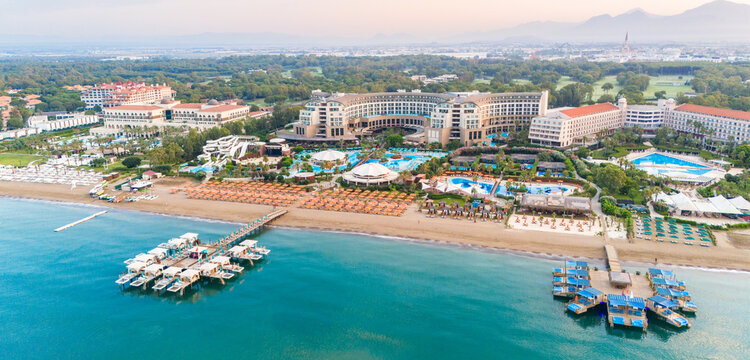 Stunning coastline with luxury hotels and private piers stretching into the serene blue ocean.