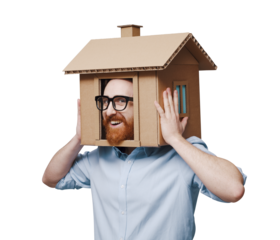 Man with head inside a cardboard house