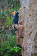 A climber climbs a sheer wall in the Marble Mountains