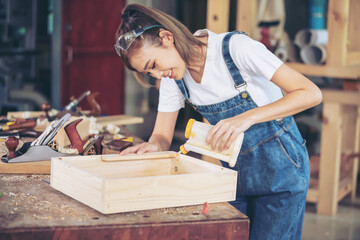 In a bustling carpenter's shop, a young woman craftsman expertly navigates her workshop, merging traditional woodwork skills with modern equipment to create hand-made furniture