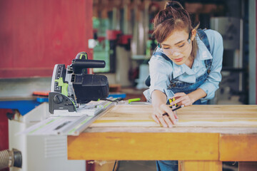 Close Up Portrait of a Young Female Artisan Carpenter Using Hand Plane to Shape a Wood Bar. Beautiful Artist Working on a Project in a Woodworking Workshop.