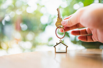 House model and key in home insurance broker agent ‘s hand or in salesman person. Real estate agent offer house, property insurance and security, affordable housing concepts