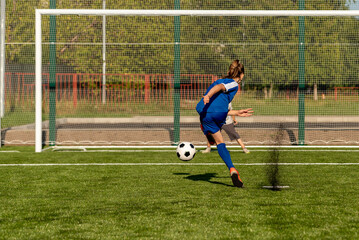 Obraz premium A penalty kick (commonly known as a penalty or a spot kick) is a method of restarting play in association football,