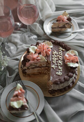 a chocolate cake with pink flowers on top of it
