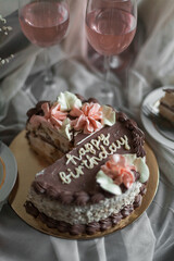 a chocolate cake with pink flowers on top of it