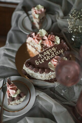 a chocolate cake with pink flowers on top of it