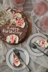 a chocolate cake with pink flowers on top of it