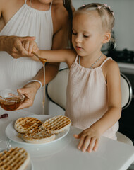 Mother and daughter preparing food in kitchen