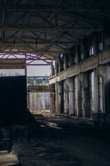 Fototapeta premium Soviet ruins of the plant. The abandoned building was overgrown with greenery and collapsed.