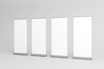 Four blank roll-up banners lined up for promotional displays.