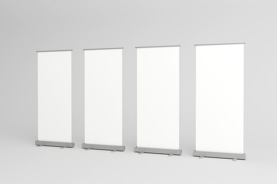 Four blank roll-up banners lined up for promotional displays.