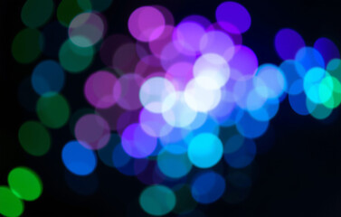 Vibrant, jewel toned bokeh effect with intense round lights in emerald green, sapphire blue, and amethyst purple