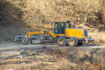 Bulldozer on old unpaved highway.