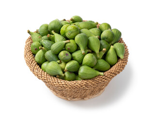 Basket with fresh picked unripe figs close up isolated on white background