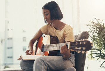 Woman, guitar and writing music in home for audio production, song composition and practice for...