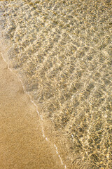 Gentle sea waves on the shore of the beach, summer vibes, relaxation, calmness 