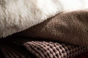 A careless stack of towels. beige or Mocha Mousse terry towel close-up