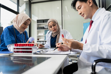 Doctors working together on laptop computer and tablet and medical stethoscope on clipboard on desk, electronics medical record system EMRs concept